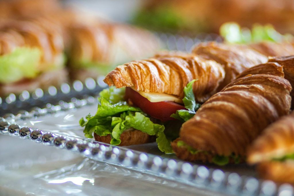 a close up of a plate of food with croissants